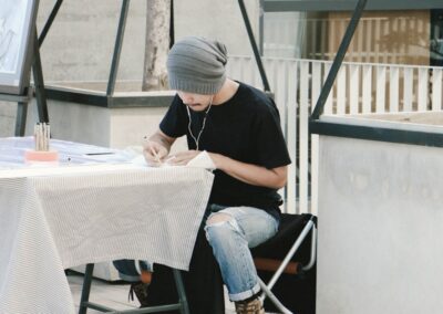 man writing on white printer paper